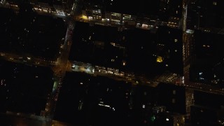 AX122_245 - 5.5K aerial stock footage of a bird's eye of Kenmare Street and stores at Night in Soho, New York City
