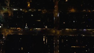 AX122_246 - 5.5K aerial stock footage of a bird's eye of city streets at Night in Soho, NYC