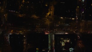 AX122_252E - 5.5K aerial stock footage of a bird's eye of Houston Street traffic through East Village at Night in New York City