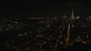 AX122_256E - 5.5K aerial stock footage orbit Manhattan Bridge and Lower Manhattan at Night in New York City
