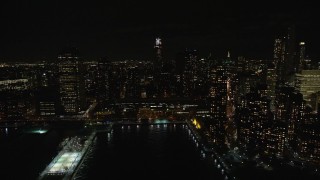 AX122_288 - 5.5K aerial stock footage of orbiting riverfront high-rises in Tribeca at Night in New York City