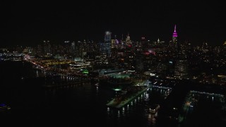 AX122_294 - 5.5K aerial stock footage of Chelsea piers and riverfront office buildings at Night in New York City