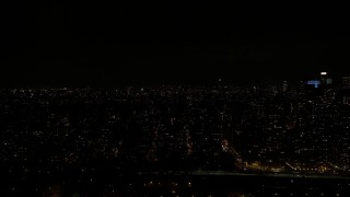AX123_016 - 5.5K aerial stock footage of passing Upper West Side high-rises at Night in New York City