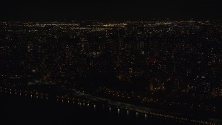 AX123_019E - 5.5K aerial stock footage of apartment buildings in Morningside Heights at Night in NYC