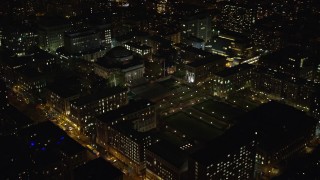 AX123_021E - 5.5K aerial stock footage approach Columbia University at Night in New York City