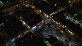 AX123_033 - 5.5K stock footage aerial video approach and bird's eye of ambulances on a Harlem street at Night in New York City