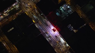 AX123_034E - 5.5K aerial stock footage of flying over 125th Street office buildings and shops in Harlem at Night in New York City