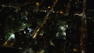AX123_039E - 5.5K stock footage aerial video fly over public housing complex in Harlem at Night, New York City