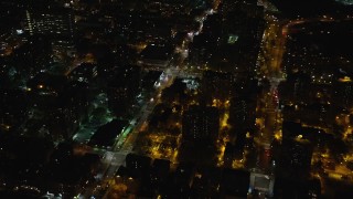 AX123_042 - 5.5K stock footage aerial video approach an intersection in Harlem at Night in NYC