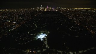 AX123_050E - 5.5K stock footage aerial video fly over Central Park toward Midtown at Night in New York City