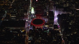 AX123_077 - 5.5K aerial stock footage of orbiting Madison Square Garden at Night in Midtown, New York City