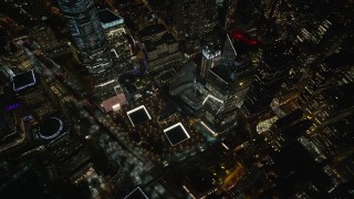 AX123_085 - 5.5K aerial stock footage of a reverse view of the World Trade Center Memorial at Night in Lower Manhattan, NYC