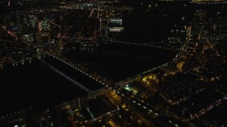 AX123_090E - 5.5K aerial stock footage orbit of the Brooklyn and Manhattan Bridges at Night in New York City