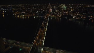 AX123_114E - 5.5K aerial stock footage of orbiting the Manhattan Bridge at Night in New York City