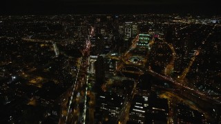 AX123_116E - 5.5K aerial stock footage fly over Manhattan Bridge to approach Brooklyn at Night in New York City
