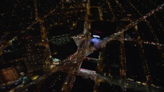 AX123_121E - 5.5K aerial stock footage of the intersection of Atlantic and Flatbush Avenues by Barclays Center at Night, NYC