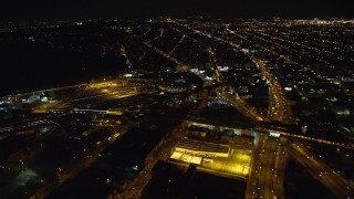AX123_130E - 5.5K stock footage aerial video approach East New York Yard at Night in Brooklyn in New York City