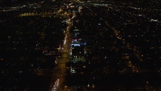 AX123_138E - 5.5K aerial stock footage of following Atlantic Avenue through Queens at Nighttime in New York City