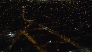 AX123_142 - 5.5K aerial stock footage of suburban neighborhoods at Night in Jamaica, New York