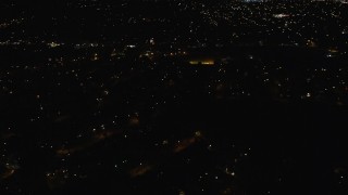 AX123_153E - 5.5K aerial stock footage of flying over suburban homes at Night in Hempstead, New York