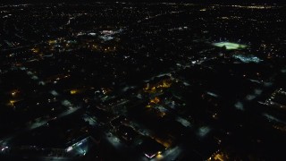 AX123_161 - 5.5K aerial stock footage fly over warehouses and suburban homes at Night in Hempstead, New York