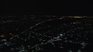 AX123_162E - 5.5K aerial stock footage fly over suburban homes at Night in Hempstead, New York