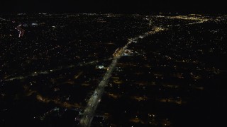 AX123_165E - 5.5K aerial stock footage approach and orbit Nassau Road and suburban homes at Night in Uniondale, New York