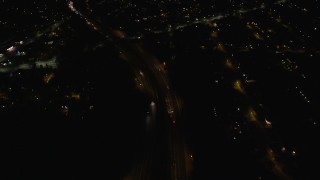 AX123_170E - 5.5K aerial stock footage of a reverse view of suburban homes at Night in Merrick, New York