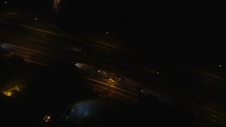 AX123_186 - 5.5K aerial stock footage of a bird's eye view of light traffic on Southern State Parkway at Night in Farmingdale, New York