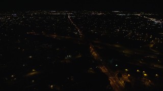 AX123_187 - 5.5K aerial stock footage orbit Southern State Parkway and Carmans Road at Night in Farmingdale, New York
