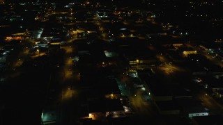 AX123_188 - 5.5K aerial stock footage orbit warehouses at Night in Farmingdale, New York