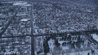 AX124_013E - 5.5K aerial stock footage fly over Liberty Park and suburbs at Sunrise in Winter, Salt Lake City, Utah