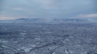 AX124_030 - 5.5K aerial stock footage of Salt Lake City suburbs at Winter Sunrise in Utah