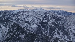 AX124_035 - 5.5K aerial stock footage approach snowy mountains in the Wasatch Range at Sunrise in Utah