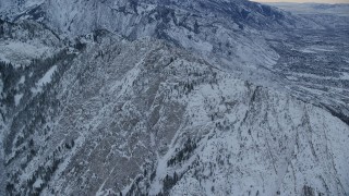 AX124_044 - 5.5K aerial stock footage approach snowy summit of Mount Olympus at winter sunrise in Utah