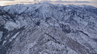 AX124_046 - 5.5K aerial stock footage fly over Mount Olympus with snow at winter sunrise in Utah