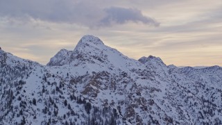 AX124_065 - 5.5K aerial stock footage of O'Sullivan Peak with winter snow in the Wasatch Range at sunrise in Utah