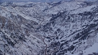AX124_070 - 5.5K aerial stock footage orbit roads and small town of Snowbird in winter at sunrise in Utah