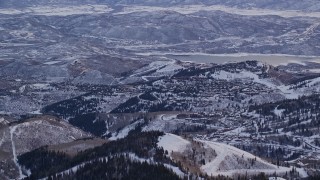 AX124_089 - 5.5K aerial stock footage orbit Deer Valley Ski Resort with winter snow at sunrise, Utah