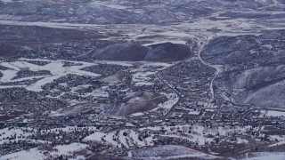 AX124_092 - 5.5K aerial stock footage orbit small town neighborhoods with winter snow at sunrise in Park City, Utah