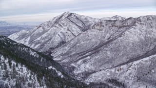AX124_164E - 5.5K aerial stock footage approach Grandeur Peak in the wintery Wasatch Range at sunrise, Utah
