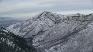 AX124_165 - 5.5K aerial stock footage approach snowy Grandeur Peak in winter at sunrise, Utah