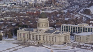 AX124_198E - 5.5K aerial stock footage of Utah State Capitol with winter snow at sunrise in Salt Lake City