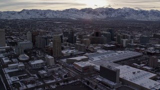 AX124_206 - 5.5K stock footage aerial video orbit Downtown Salt Lake City and Salt Lake Temple in winter at sunrise in Utah