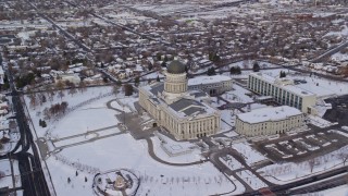 AX124_216E - 5.5K aerial stock footage approach Utah State Capitol from Downtown and orbit the building, in winter at sunrise, Salt Lake City
