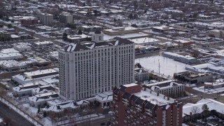 AX124_226 - 5.5K aerial stock footage orbit the Grand America Hotel in Downtown Salt Lake City with winter snow at sunrise, Utah