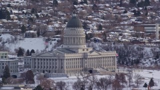 AX124_228E - 5.5K aerial stock footage orbit the Utah State Capitol with winter snow at sunrise, Salt Lake City