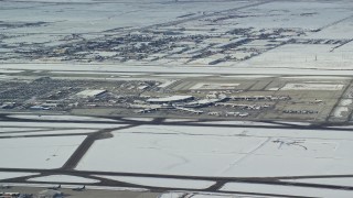 AX125_008 - 5.5K aerial stock footage of Salt Lake City International Airport with winter snow, Utah