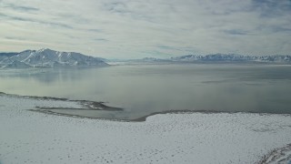 AX125_099 - 5.5K aerial stock footage of the Great Salt Lake seen from Antelope Island in winter, Utah