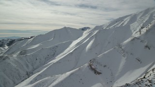 AX125_121 - 5.5K aerial stock footage of frozen winter slopes in the Oquirrh Mountains, Utah